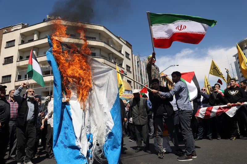 Iranians burn an Israeli flag during a rally marking Quds Day and the funeral of the IRGC members, in Tehran. Reuters