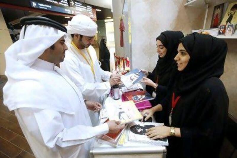 Majeda Ahmed al Musalli, second from right, and Alanood Salem display their wares at the competition.