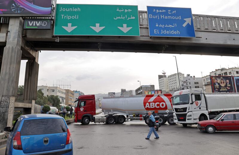 Tankers block a road in Lebanon's capital Beirut during a general strike by public transport and workers' unions over the country's economic crisis, on January 13, 2022. AFP