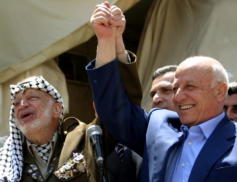 Palestinian president Yasser Arafat with Mr Qurei in Ramallah in July 2004, after the latter had withdrawn his resignation as prime minister. Reuters