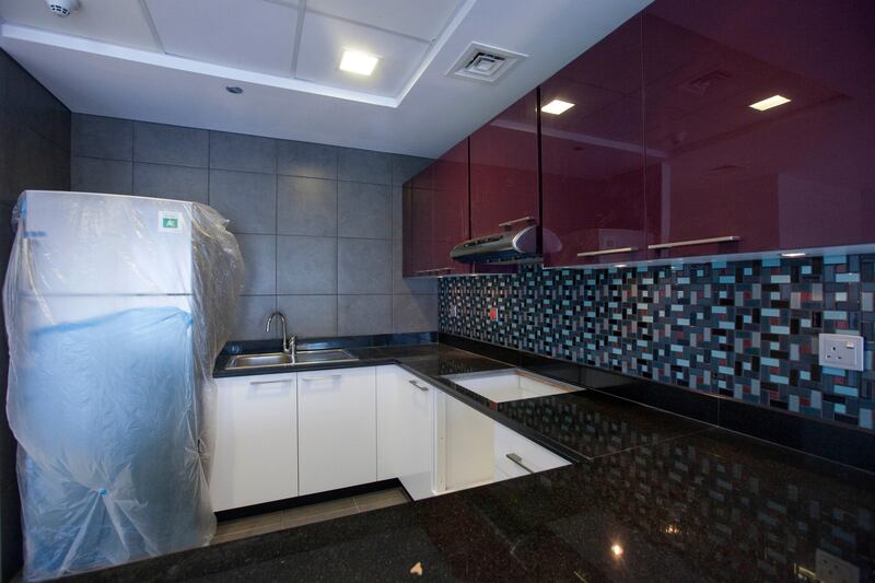 Dubai, United Arab Emirates - June 11 2013 - The interior of a 7th floor two-bedroom apartment at the Cayan Tower in the Dubai Marina.  Seen here is the kitchen. (Razan Alzayani / The National)