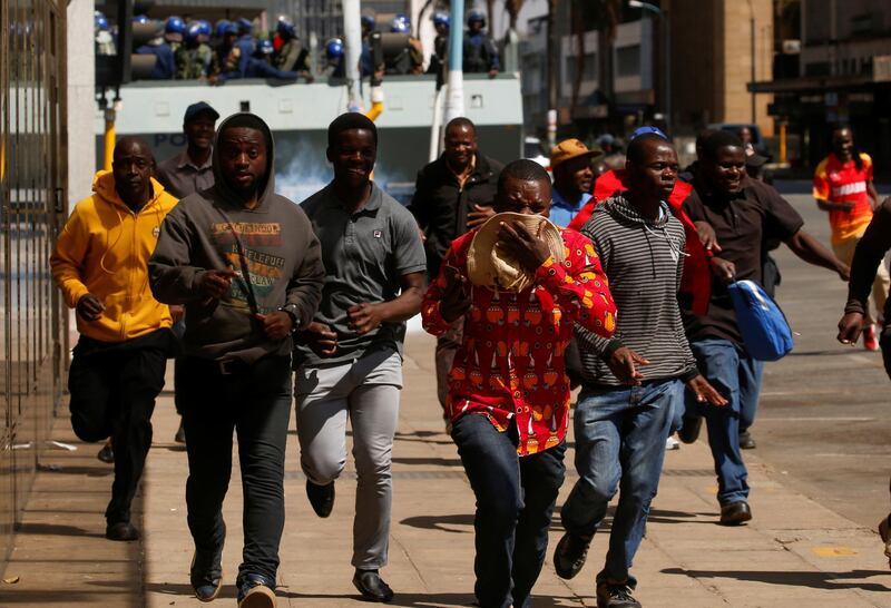 Protesters flee from teargas during clashes with the police in Harare, Zimbabwe. Reuters