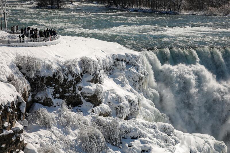 Visitors view water flowing around the ice at the American Falls due to cold temperatures in Niagara Falls, US. Reuters