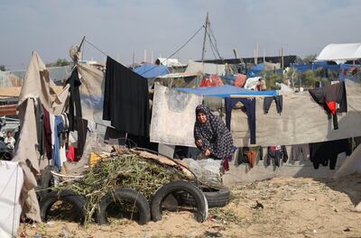 A woman works in a tent camp for displaced Palestinians in the southern Gaza Strip. Reuters