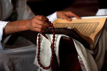 A man holds a prayer bead as he reads the holy Koran at a mosque during the Muslim holy fasting month of Ramadan amid the ongoing coronavirus COVID-19 pandemic, in Sana'a, Yemen, 08 May 2020. Muslims around the world celebrate the holy month of Ramadan, by praying during the night time and abstaining from eating, drinking, and sexual acts during the period between sunrise and sunset. Ramadan is the ninth month in the Islamic calendar and it is believed that the revelation of the first verse in Koran was during its last 10 nights. EPA/YAHYA ARHAB