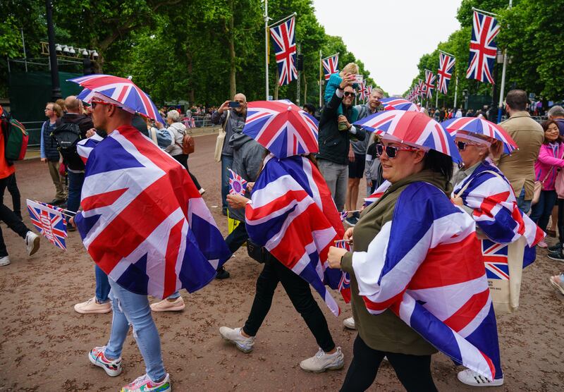 Spectators cross the Mall before the Platinum Jubilee Pageant in front of Buckingham Palace on day four of the celebrations. PA