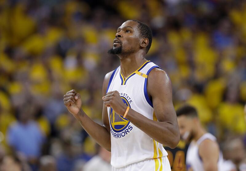 FILE - In this June 12, 2017 file photo, Golden State Warriors forward Kevin Durant reacts after scoring against the Cleveland Cavaliers during the second half of Game 5 of basketball's NBA Finals in Oakland, Calif. A person with knowledge of the situation tells The Associated Press that Durant has agreed to terms on a two-year deal worth about $53 million to remain with the Golden State Warriors. The deal calls for about $25 million in the first year with a player option for the second season. The person spoke on condition of anonymity because the contract cannot be signed until Thursday, July 6, 2017. (AP Photo/Marcio Jose Sanchez, File)