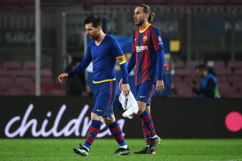 Messi (L) and Barcelona's Spanish defender Oscar Mingueza walk off the pitch. AFP