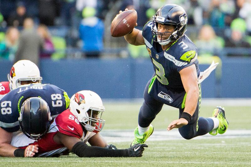 Dec 31, 2017; Seattle, WA, USA; Arizona Cardinals outside linebacker Chandler Jones (55) trips up Seattle Seahawks quarterback Russell Wilson (3) during the second half during a game at CenturyLink Field. The Cardinals won 26-24. Mandatory Credit: Troy Wayrynen-USA TODAY Sports