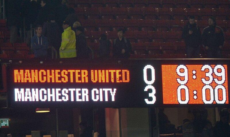 The scoreboard displays the score during the derby between Manchester United and Manchester City at Old Trafford on Tuesday, which  Manchester City won 3-0. Paul Ellis / AFP / March 25, 2014