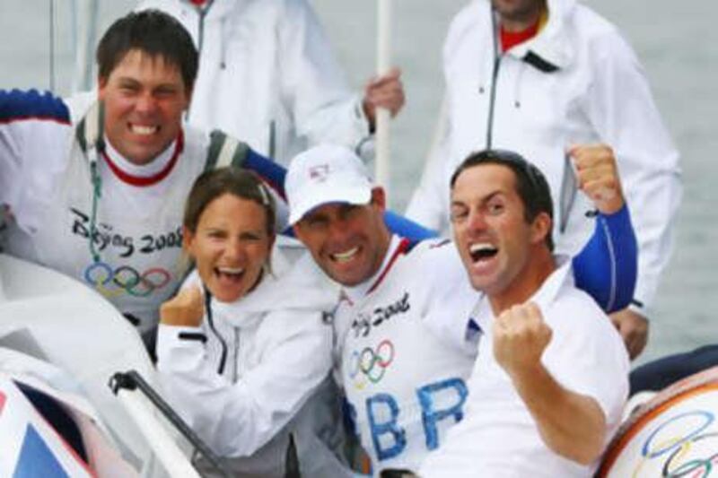 Andrew Simpson, RS:X windsurfer bronze medallist Bryony Shaw, Iain Percy and Finn gold medalist Ben Ainslie all of Great Britain celebrate after Percy and Simpson win gold medal in the star class event.