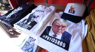 T-shirts and hats with the mugshot of former US President Donald Trump at the Y-Que printing store in Los Angeles, California, on August 26. Reuters