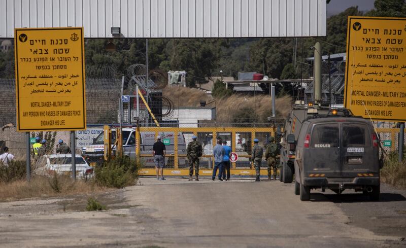 Israeli and UN soldiers at Quneitra Crossing on the Israeli- Syrian border as an ambulance transporting Wafaa Nasrallah, a resident of Majdal Shams and daughter of the last remaining indigenous Orthodox Christian family in the Golan Heights. Nasrallah left the Golans in the 90s  to pursue a university degree in medicine at  Damascus University, three years ago she fell into a coma. Syrian and Israeli authorities have allowed her to return to her home town via the Quneitra crossing that was shut down for many years due to the ongoing conflict in Syria.  EPA