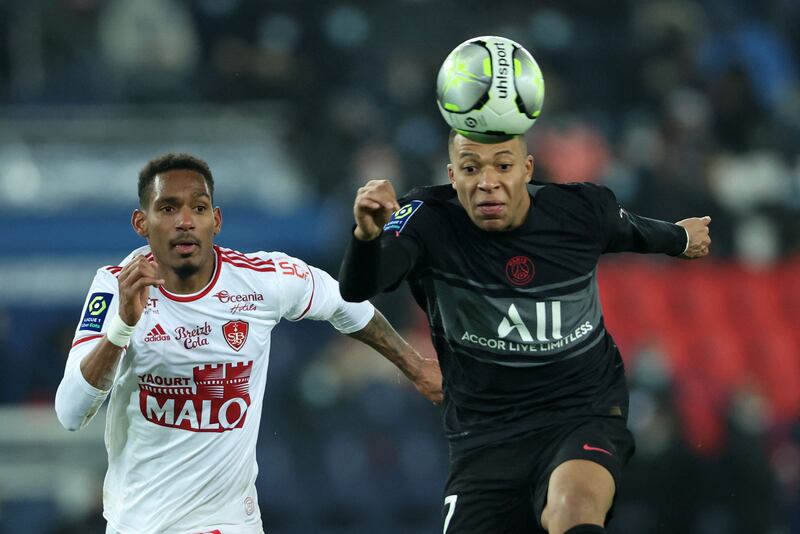 Paris Saint-Germain's Kylian Mbappe and Brest's Christophe Herelle fight for the ball . AFP