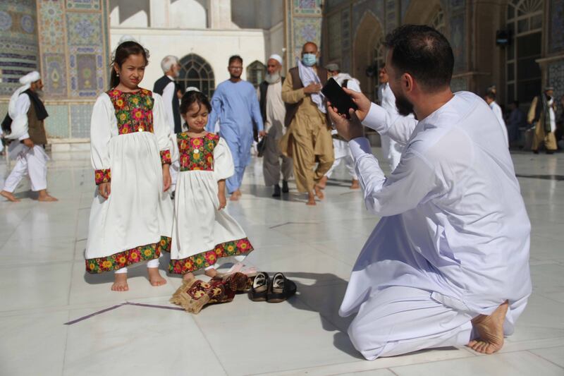 In this April 2021 photo, an Afghan family visits one of Herat's historic mosques to offer Eid Al Adha prayers. EPA