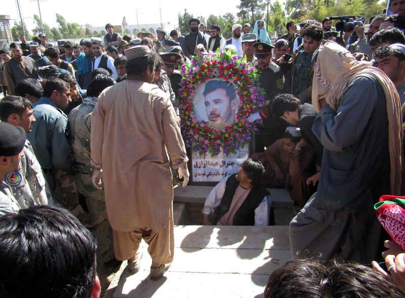 People attend the burial ceremony of General Abdul Razeq, the Kandahar police commander who was killed in Thurday's attack in Kandahar, Afghanistan. Reuters