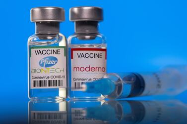 Vials with Pfizer-BioNTech and Moderna coronavirus disease (Covid-19) vaccine labels are seen in this illustration picture taken March 19, 2021. Reuters