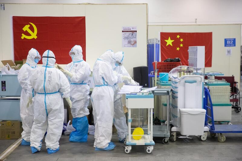 Medical staff in protective suits work at Wuhan Fang Cang makeshift hospital in Wuhan, Hubei Province, China.  EPA