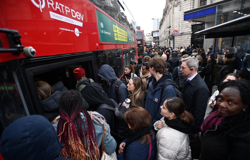 People queue for buses outside Victoria  Station in London. EPA