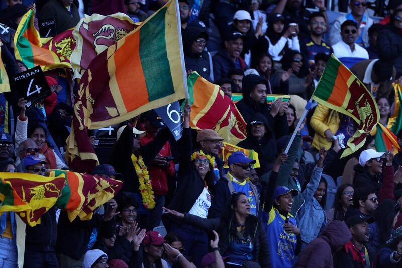 Cricket fans wave Sri Lankan flags during the T20 World Cup Cricket match between Sri Lanka and Namibia. AP