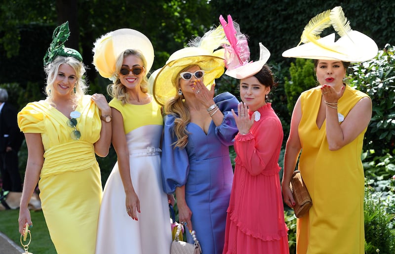 Visitors wear fancy hats as they attend Ladies' Day at Royal Ascot on Thursday. EPA