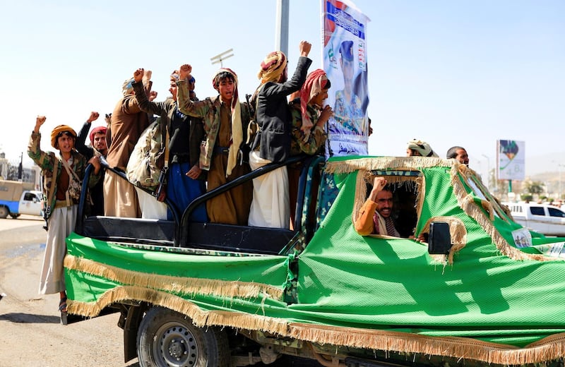Fighters loyal to Yemen's Houthi rebels chant slogans as they travel to the funeral of rebels killed in fighting with government troops. AFP