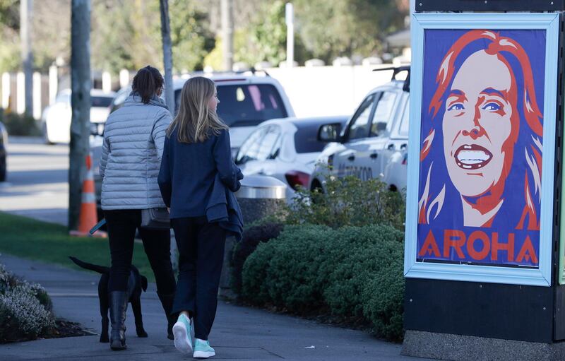 Pedestrians walk past a billboard featuring Prime Minister Jacinda Ardern with the word Aroha, meaning love, in Christchurch, New Zealand. AP Photo