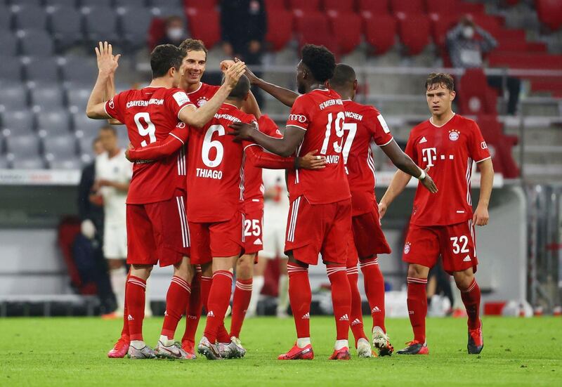 Bayern Munich's Robert Lewandowski celebrates with teammates after scoring the winning goal. AP
