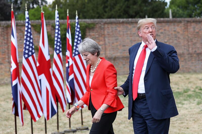 FILE: U.S. President Donald Trump, speaks to the media as he holds onto Theresa May, U.K. prime minister, following their joint news conference at Chequers in Aylesbury, U.K., on Friday, July 13, 2018. An emotional Theresa May announced she will quit as Britain’s prime minister after admitting she had failed to deliver the one task that defined her time in office -- taking the country out of the European Union. Photographer: Chris Ratcliffe/Bloomberg