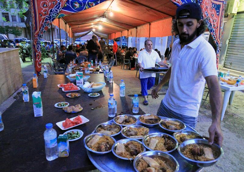 A Libyan lays out dishes on a tray to be served for iftar in Benghazi.  AFP