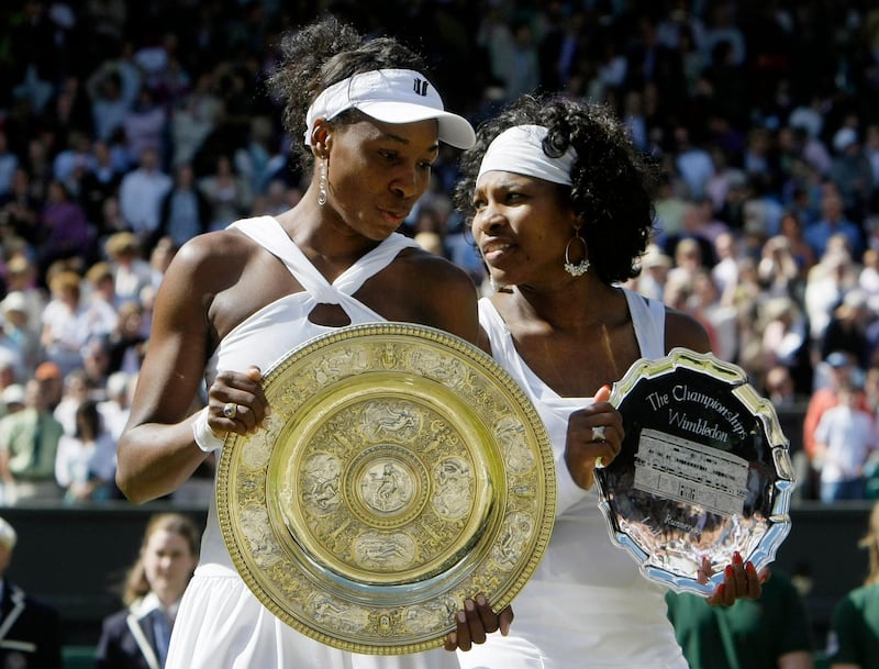 Venus Williams left, of the US holds her trophy after winning the women's singles final against her sister Serena right, on the Centre Court at Wimbledon, Saturday, July 5 , 2008. (AP Photo/Anja Niedringhaus)