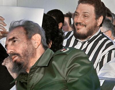 (FILES) File photo dated on February, 2002 of Castro's elder son, nuclear physicist Fidel Castro Diaz-Balart (R), next to his father, Cuban leader Fidel Castro, during the Havana Book Fair opening.
Fidel Castro's eldest son committed suicide: Cuba state media on February 1, 2018. / AFP PHOTO / Adalberto ROQUE