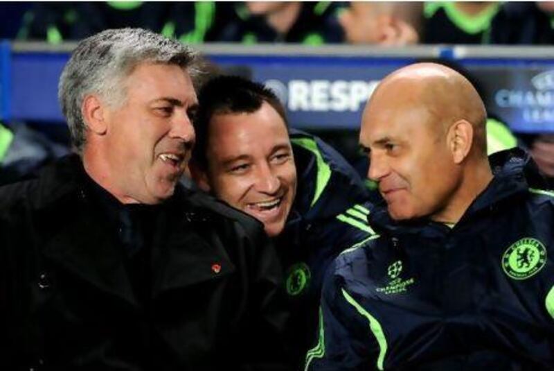Ancelotti, left, shares a moment with captain, John Terry, centre, and former assistant coach Ray Wilkins, who was sacked last month. 
Darren Walsh / Getty Images