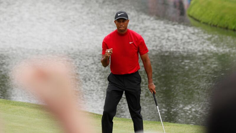Tiger Woods reacts to his birdie on the 16th hole during the final round. Justin Lane / EPA