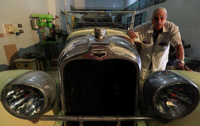 Sayed Sima stands next to a 120-year-old American 900 Auburn automobile in his store. Reuters