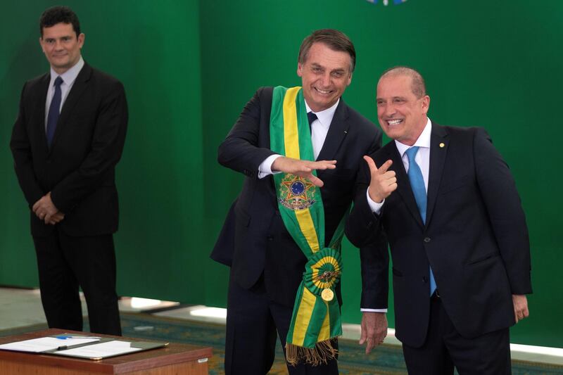 epa07257569 Brazilian newly inaugurated President Jair Bolsonaro (C) welcomes new Brazilian Chief Minister of the Civil House Onyx Lorenzoni (R), during his inauguration ceremony at the Planalto Palace in Brasilia, Brazil, 01 January 2019. A far-right president leads the biggest Latin America democracy for first time since the end of military rule (1964-1985). Bolsonaro defeated candidate Fernando Haddad in the runoff, held last October, receiving 55 percent of the vote.  EPA/JOEDSON ALVES