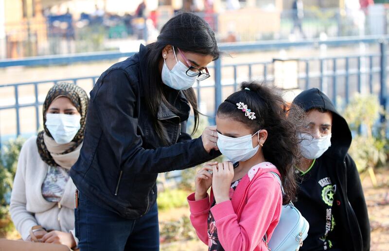 People wear protective masks as they visit Global Village in Dubai.  EPA