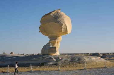 epa09006371 Tourists visit the mushroom, a massive white inselberg that are characteristic of Egypt's White Desert which is located 500 km southwest of Cairo, Egypt, 07 February 2021, (issued 12 February 2021). Egypt is unique in the variety of desert oasis as Al Farafra Oasis, Swia and Al Bahria Oasis that attract tourists from all over the world to enjoy safaris in the sunny weather. The Supreme Council of Antiquities introduced the 'Spend Winter in Egypt' initiative in January 2021 to encourage domestic tourism. Flights to various destinations are offered at flat rates from 15 January to 28 February and a there is a 50 per cent discount for Egyptians on tickets at the archaeological areas and museums in various governorates in January and February. The ministry has emphasized the importance to keep precautionary measures and health safety controls at all sites. EPA/KHALED ELFIQI ATTENTION: This Image is part of a PHOTO SET