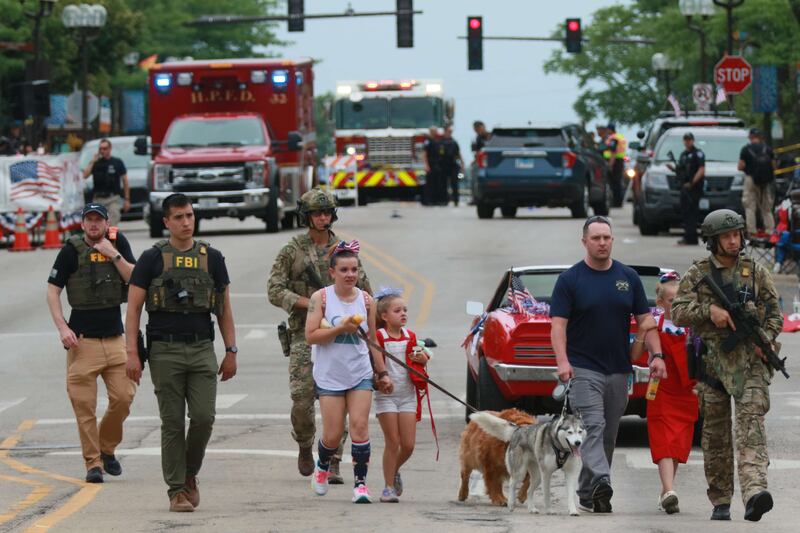 Families are escorted away from the scene. AFP