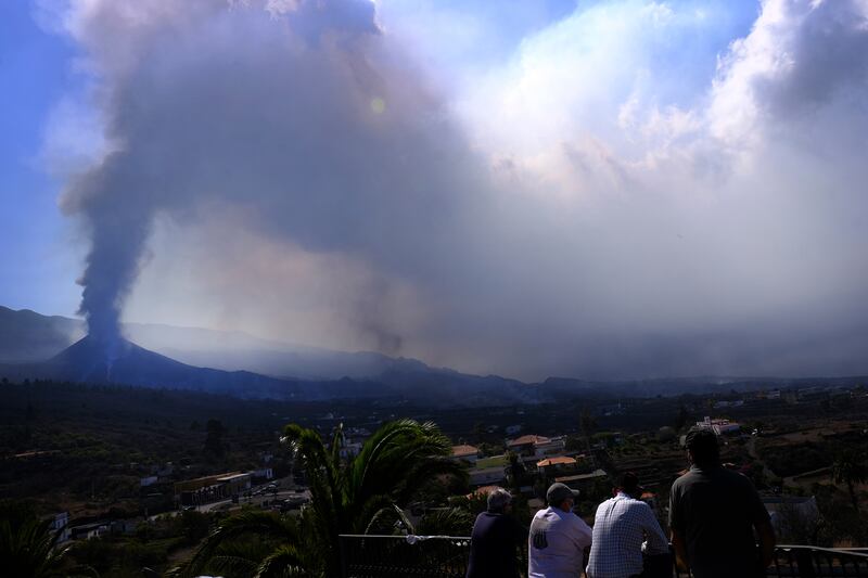People look towards a volcano as it continues to erupt in El Paso on the canary island of La Palma, Spain. AP Photo