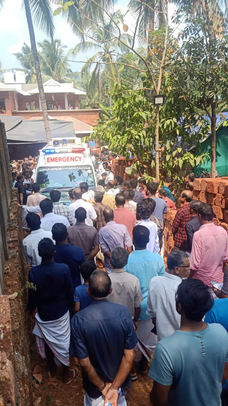 Crowds of mourners outside the couple's home in India. Photo: Kalangadan and Kandamangalath family