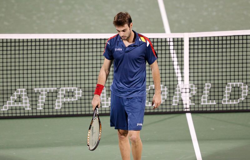 Marcel Granollers of Spain reacts after hitting a return to Roger Federer of Switzerland during their men's singles match at the ATP Dubai Tennis Championships, February 27, 2013. REUTERS/Ahmed Jadallah (UNITED ARAB EMIRATES - Tags: SPORT TENNIS) *** Local Caption ***  AJS04_TENNIS-MEN-DU_0227_11.JPG