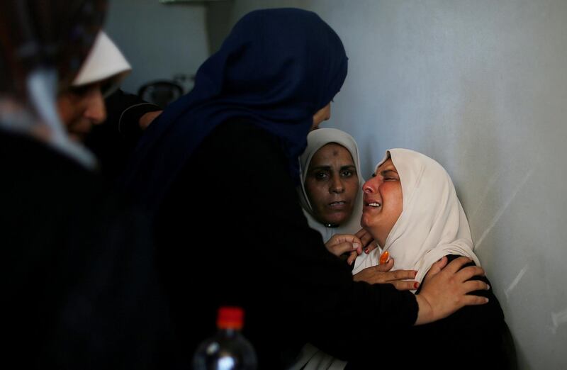 A relative of Palestinian Emad Ishtawi, who was killed during a protest along the Israel-Gaza border fence, is comforted as she mourns during his funeral in Gaza City. Reuters