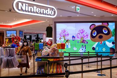 A screen showing the characters from the widely popular Animal Crossing series video game is seen at a Nintendo store in Tokyo. AFP