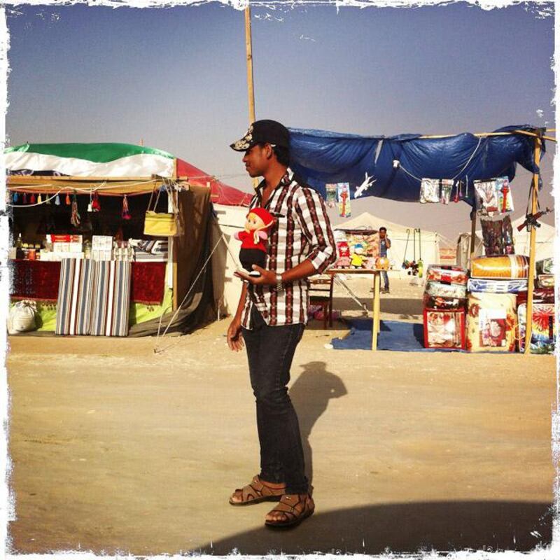 Day trip with friends to the Western Region and the Mazayin Dhafra Camel Festival, 220 kms west of Abu Dhabi on December 20, 2013.  A man selling a stuffed toy on the side of the road.  Picture taken with the Hipstamatic app for the iPhone. Liz Claus / The National

