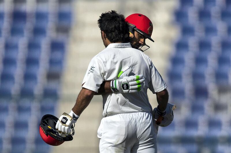 Abu Dhabi, United Arab Emirates, November 29, 2017:    Ihsanullah of Afghanistan, right, congratulates teammate Rahmat Shah on scoring a century during their ICC Intercontinental Cup cricket match at Zayed Cricket Stadium in the Khalifa City area of Abu Dhabi on November 29, 2017. Christopher Pike / The National

Reporter: Amith Passela
Section: Sport