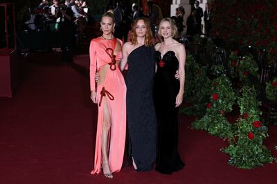 Poppy Delevingne, Stella McCartney and Carey Mulligan pose on the red carpet at London's Theatre Royal Drury Lane. Reuters