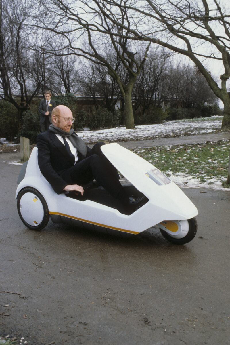 Sir Clive Sinclair demonstrating his C5 electric vehicle in 1985. PA