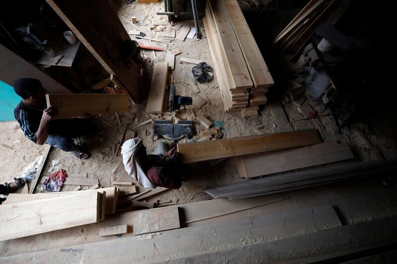 A Yemeni labourer works at a wood shop on International Labour Day in the country's capital, Sanaa. International Labour Day, or May Day, is observed annually on 1 May around the world and celebrates workers, their rights, achievements and contributions to society. EPA