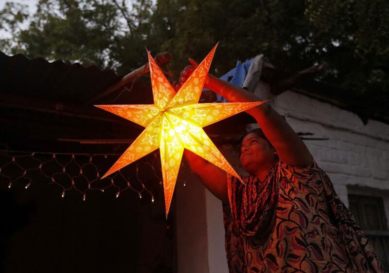 A woman decorates the exterior of her house ahead of the Christmas celebrations in Ahmedabad, India.  Amit Dave / Reuters